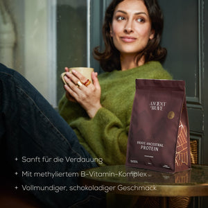 Woman holding a mug with a package of Brave Ancestral Protein 